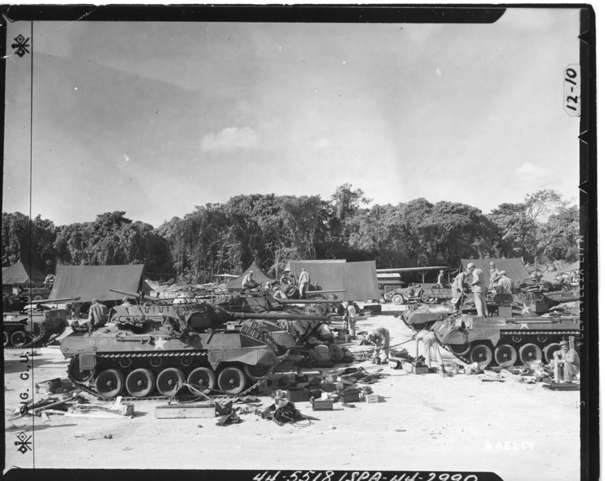 Some M18s saw service in the Pacific theater, such as these vehicles assigned to the 637th Tank Destroyer Battalion on Espiritu Santo, New Hebrides, on Aug. 4, 1944. The crewmen are performing maintenance on their equipment; one of them at the center of the photo is greasing a tow cable.