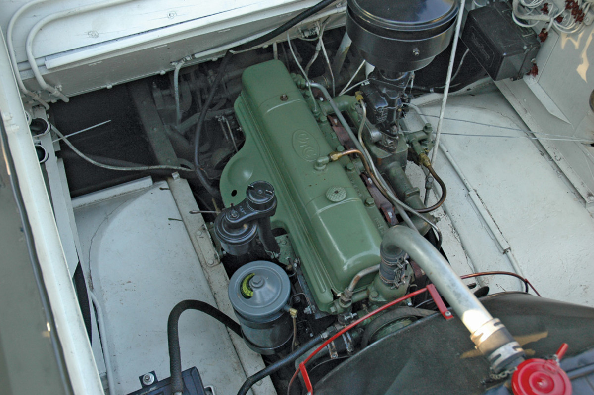 Following the failure of the ignition system during the Kitty Hawk sea trials, provision was made to protect the ignition components of the GMC Model 270 six-cylinder inline engine which powered the DUKW. The ignition coil, cables, and distributor are under the light green cover to the left of engine block as seen in the photo, with the black engine crankcase breather protruding above the cover. The oil-bath filter sits above the carburetor to the other side of the engine. The fan shroud and radiator are to the bottom.