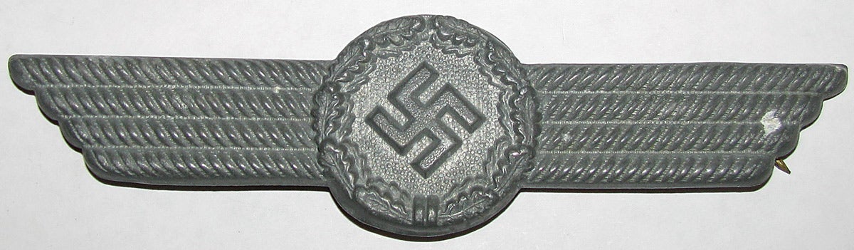 The lower visor cap insignia worn by doormen, guards and elevator operators at the Ministry of Aviation, the organization that oversaw the development and building of all Luftwaffe (and civilian) aircraft.