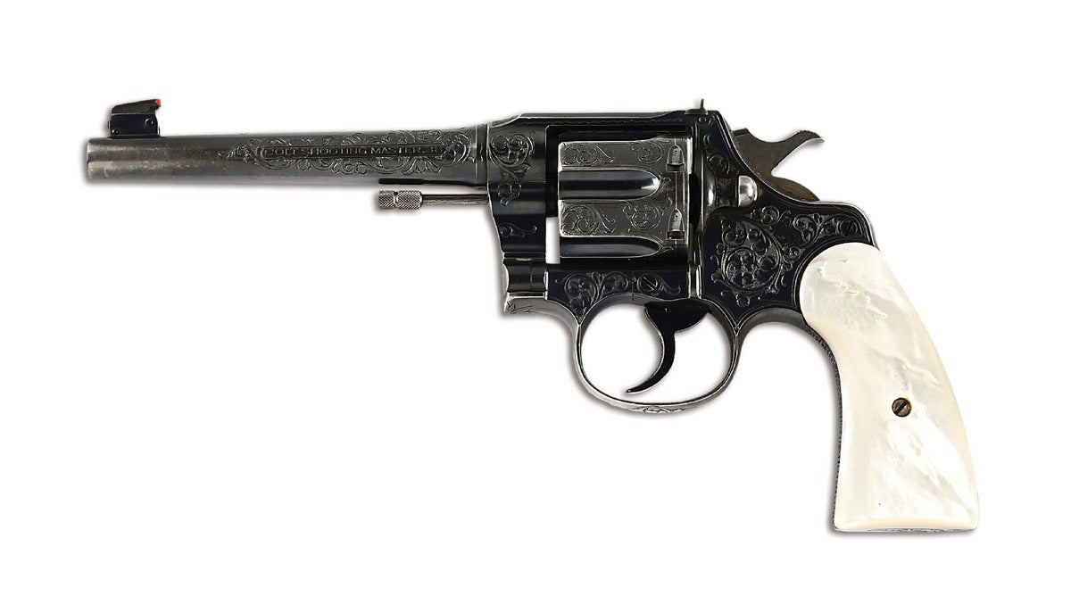 Colt Shooting Master .38 Special Double-Action Revolver factory-engraved with acanthus scrollwork. Per accompanying factory letter, gun was sent in a shipment of one on July 14, 1932 to MacFarlane and Co., Watsonville, California. Extremely scarce, one of as few as 10 known examples of a factory-engraved Shooting Master. Mechanically fine, very smooth, excellent bore.