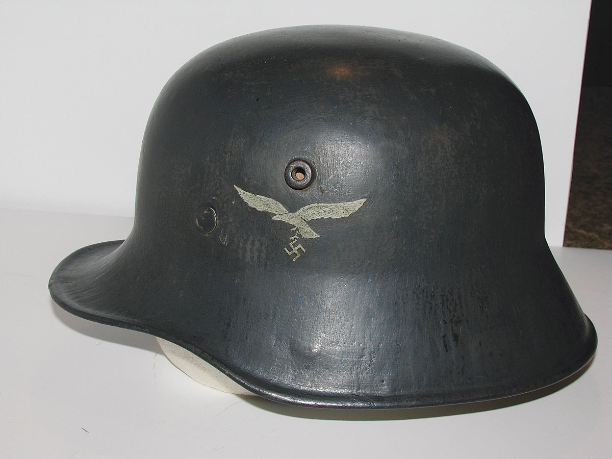 A model 1918 transitional helmet, repainted in Luftwaffe blue with a side eagle emblem. These were used until the issuance of the 1935 models.