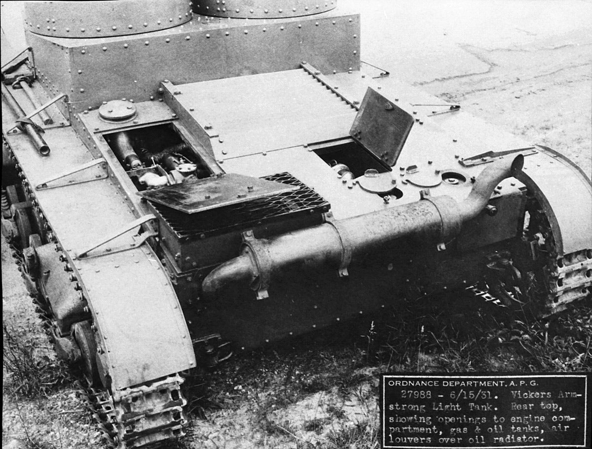 The covers to the engine compartment and the gas and oil tanks are all open in this shot.