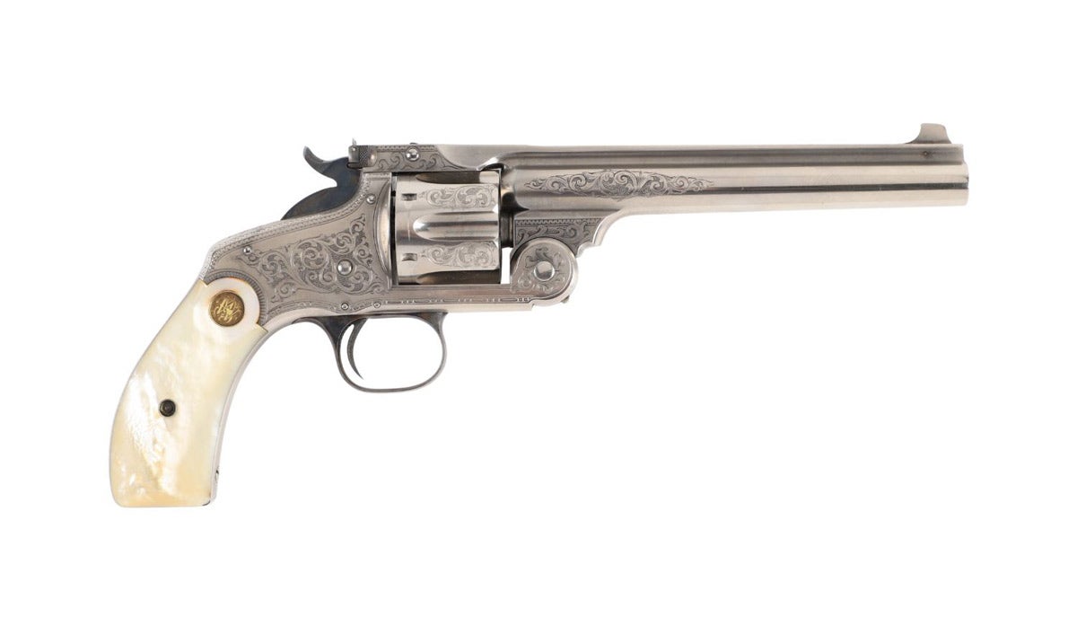 Circa 1891 American Smith & Wesson factory engraved, new model revolver, 44 S&W Russian caliber, mechanically fine with bright case colors, near-perfect grips (est. CA$14,160).