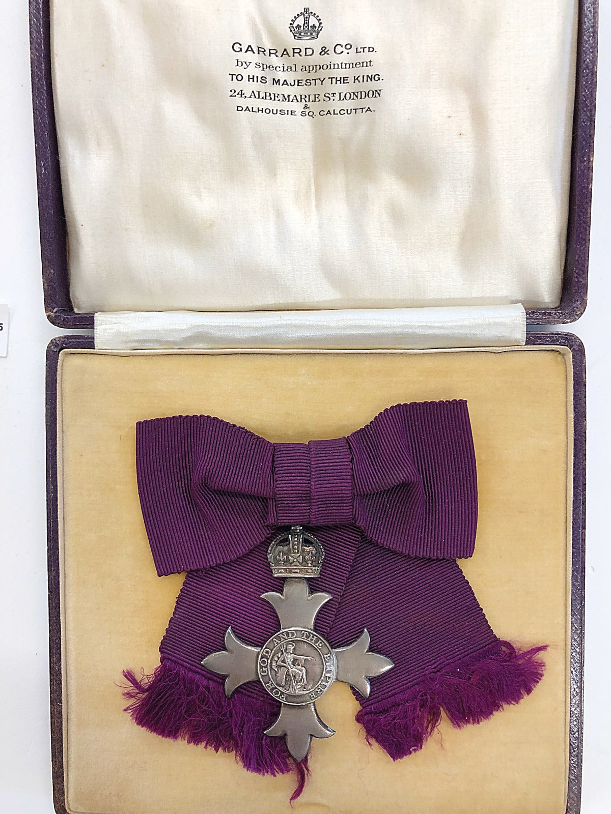 The 42mm x 42mm four arm silver cross patonce is displayed in its original Garrard & Co. Ltd. Case.