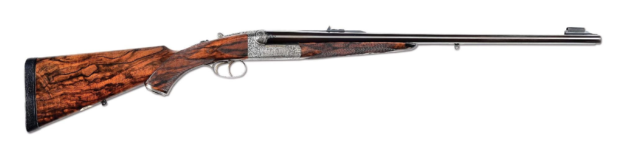 Circa-2009 Westley Richards Droplock .470 Double Rifle with scenes of big game (cape buffalo, rhinos, elephant) engraved/signed by Peter Spode, ‘P. Spode ‘09.’ Engraved over chambers ‘CAL. .470 NITRO-EXPRESS’ and ‘REG. FOR 500 GRN. BULLET.’ Chopper lump barrels with the manufacturer’s patented flip-over front sight. Wide concave rib gold-inlaid with the name ‘WESTLEY RICHARDS & Co ENGLAND.’ With Westley Richards case and accessories. Sold for $96,000 against an estimate of $45,000-$65,000