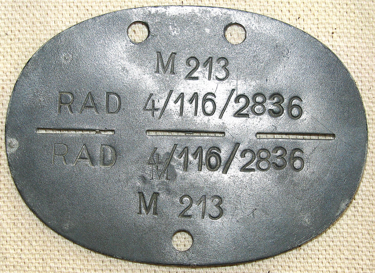 Soldiers were not the only wearers of dog tags. This “Reichsarbeitsdienst” (RAD) id disk was stamped “in a hurry”. The lettering both top and bottom runs the same way, and there is an over stamped mistake (“M”) on the bottom half.