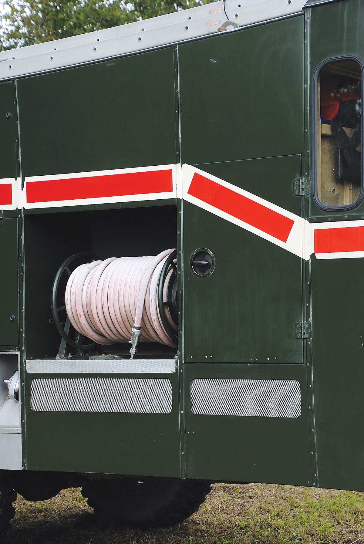 The hose reels could each hold 180 feet of coiled hose on either side of the vehicle. The red stripe down the side made the Green Goddess very distinctive.