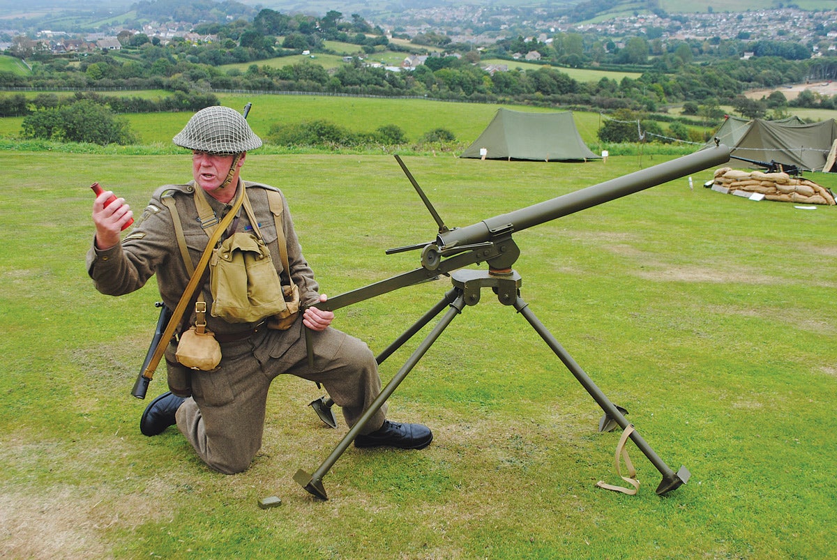 A British Home Guard 
re-enactor demonstrates a replica example of a Northover Projector. The red bottle is the projectile and would have been filled with petrol (gasoline) and white phosphorous.