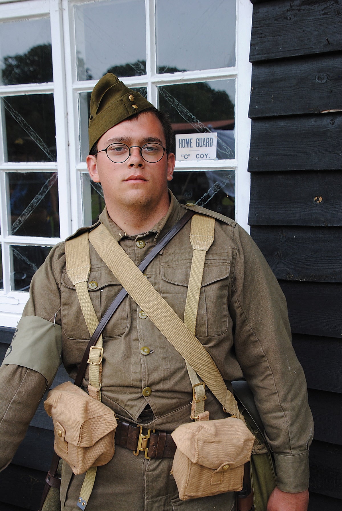 A young re-enactor wearing the cotton denim uniform as issued in the early days. He is wearing a leather belt with pouches of the style.