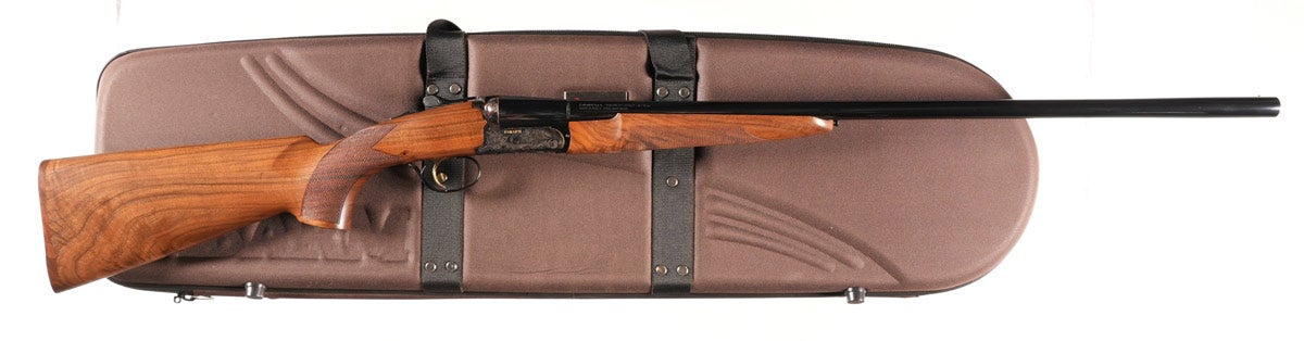 Fabarm Autumn 20 gauge double shotgun, Serial #T11655, with 28in barrel, single selective trigger and ejectors, 3in steel shot certified chambers with patented Tribore construction and five long-screw choke tubes and wrench. Select-grade Turkish walnut checkered pistol grip stocks. Richly case-colored receiver with scroll engraving and gold accents at trigger and trigger guard. Four locking blocks prevent action from ever getting off face, even with the heaviest of use. 14 5/8" LOP over wood butt plate, 1½in DAC, 2 3/8in DAH. Excellent condition with no evidence of use. Mechanically excellent. Factory box with luggage case and all instructions.