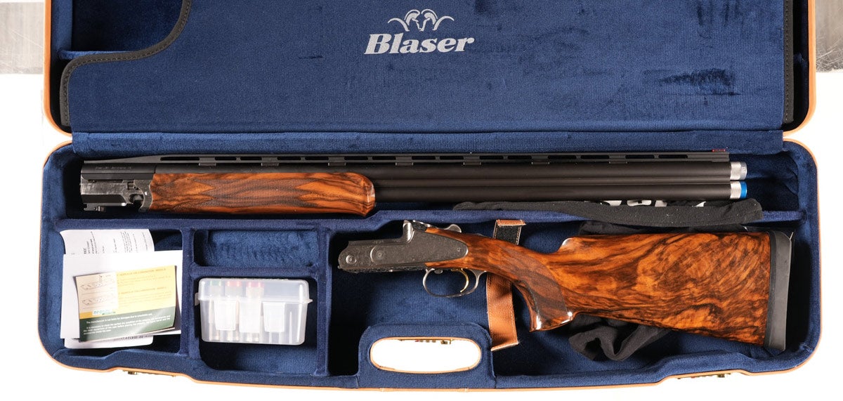 Blaser 12 gauge F3 over under shotgun, Serial #FR015626, with sporting sideplate receiver, 30in raised-vent rib barrel, 3in chambers, single selective trigger with ejectors. French grey receiver profusely engraved by Bonsi Brothers in their Heritage (vine & scroll) pattern. Varnished checkered pistol grips and competition stock of highly figured burl walnut with matching forearm. Comes complete with five extended choke tubes, wrench, takedown tools and barrel weights. Mechanically excellent. Exceptionally fine condition with little or no use evident. Factory luggage case in equally fine condition, retaining factory slip cases.