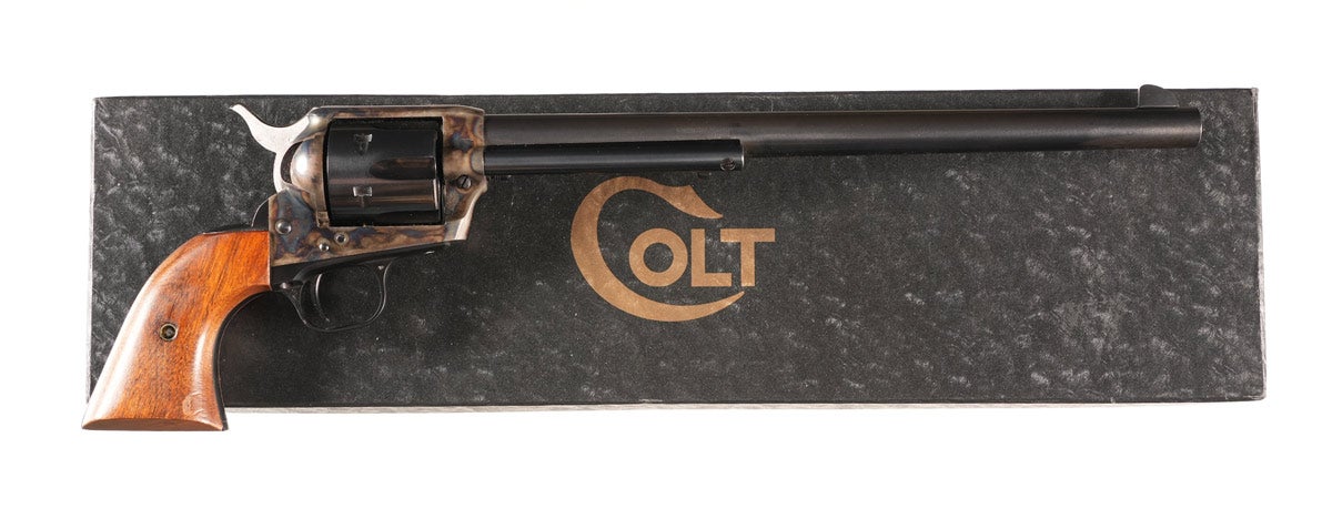 Colt .45 Second Generation Buntline Special Single Action Revolver, Serial #65497SA, with 12in barrel, blue and case color, finished with two-piece walnut grips. Manufactured in 1973. Excellent condition with 99% finish with slight trace of box wear at muzzle and some light rubs on grips. Mechanically excellent. Comes in contemporary black box with full Buntline label.