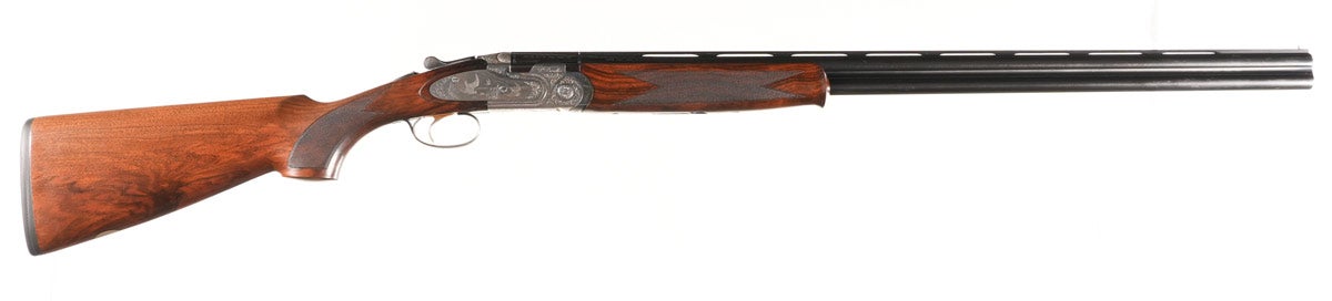 Beretta Model 687 EELL 20 gauge over/under shotgun, Serial #M60500B, 3in chambers, single selective trigger and ejectors. Choked Modified & IC (Improved Cylinder). Engraved with game scene. Gold-accented trigger. Oil-finished walnut stock with factory pad. Very good condition with 98% metal finish with brilliant bores. Stocks have some minor impressions. Mechanically excellent.