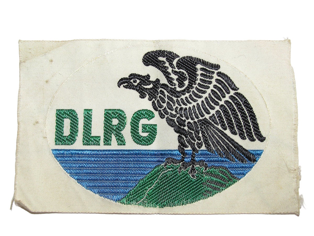 A DLRG membership patch showing that the recipient has been certified to rescue others from the water. These were often worn on swimming apparel or sports jackets.