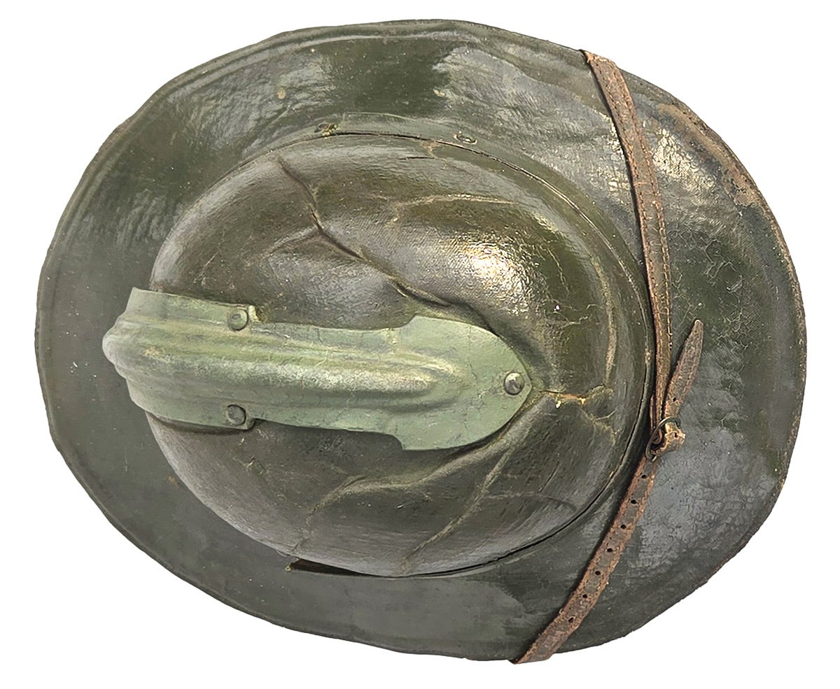 It features the comb of the French Model 1915, but the shape of the helmet dome is similar to the British Mk I steel helmet. From above, the increased size of the dome is apparent.