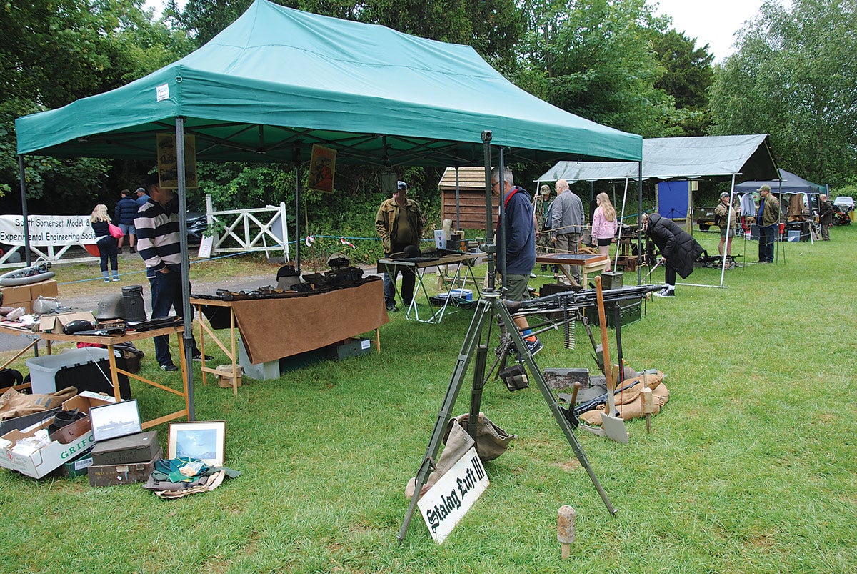 A collector displaying items for visitors to examine.