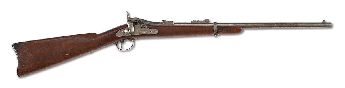 Important Springfield Model 1873 trapdoor carbine linked to Custer’s Last Stand and forensically documented by the Custer Battlefield Firearms Identification Project to fired casings recovered from the battlefield. Conveys with notarized Custer Battlefield Identification Project letter signed by Dr. Douglas D. Scott and Dick Harmon which records specimen numbers of 19 recovered casings that are matched to this carbine. High-arch breech block marked ‘MODEL / 1873 / US’ with eagle head and arrow devices. Early lockplate marked ‘U.S. / SPRINGFIELD / 1873’ with federal eagle. VG condition. Provenance: Carbine was discovered prior to testing at a California gun show. Ex Glen Swanson Collection. Julia's Lot 2287, October 2013.
