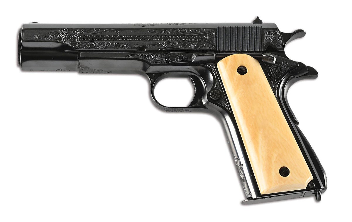 Fresh-to-the-market factory-engraved Colt 1911A1 with Colt Archives letter. Originally shipped to Loan Account, Tritch Hardware Co., Denver, Colo., Oct. 16, 1925 in shipment of 1. Half-moon front sight, U-notch flat-top rear sight, checkered spurred hammer, checkered small parts, long A1 grip safety, arched mainspring housing with lanyard loop, and smooth ivory grips (replacements from slightly after the period). Grips signed on interior ‘F. L. Belmay / 1948.’ Engraving and patterns consistent with signed examples from William Gough or his workshop. Condition: Excellent.