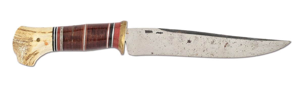 Early 20th-century Bowie knife crafted by legendary knife-maker William "Bill" Scagel. Features 7¼in Bowie-style blade with pronounced clip point blade. Reverse cheek marked ‘W. SCAGEL / HANDMADE’ in small lettering with Scagel’s signature kris mark. Provenance: obtained at Scagel's property by John Gordon Breland, a retired Muskegon, Michigan policeman who did carpentry work for Scagel.