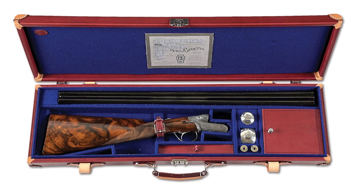 Cased Beretta 490 Serpentina 20 bore side-by-side shotgun with fabulous engraving. ‘BERETTA’ engraved over chambers. Underside of barrels with Italian proofs for a 20 gauge at a nominal 16.0 IBD proofed at 1,160 KG. CU date code for 2019. Muzzles are fit for thin wall chokes, currently fit with Full in left barrel and Modified in right. Underside has vignette with the famous Beretta villa, and portrait of a pointer. Outstanding acanthus scrollwork and beaded edges on stippled and blackened ground. Engraving signed on trigger guard plate by Cedoni and Toresani. Beretta certificate also lists Luca Casali as engraver. Condition: Excellent, new/old stock or equivalent. Does not appear to have been fired since proof.