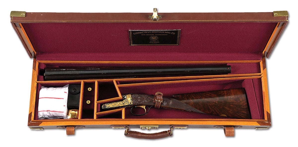 Spectacular .410 bore Connecticut Shotgun Manufacturing Co. (CSMC) Winchester Model 21 side-by-side ejector shotgun presented to President George H.W. Bush (1924-2018). English stock, gold-plated single selectable mechanical trigger, auto-safety, hold open top lever, raised matted vent rib, single red front bead, beavertail forend, gold inlaid ‘SAFE’ ahead of the safety catch, ‘R’ and ‘L’ for barrel selection by the trigger, and serial number on top strap. Gold-inlaid engraving performed and signed by Thierry Duguet. Program has Presidential motif with stars, Presidential Seal, bald eagle, etc. ‘PRESIDENT GEORGE H.W. BUSH’ engraved on top of left barrel and underside of right barrel. Brass-cornered oak and leather case with full complement of unused accessories. Condition: as new and appearing unfired. 