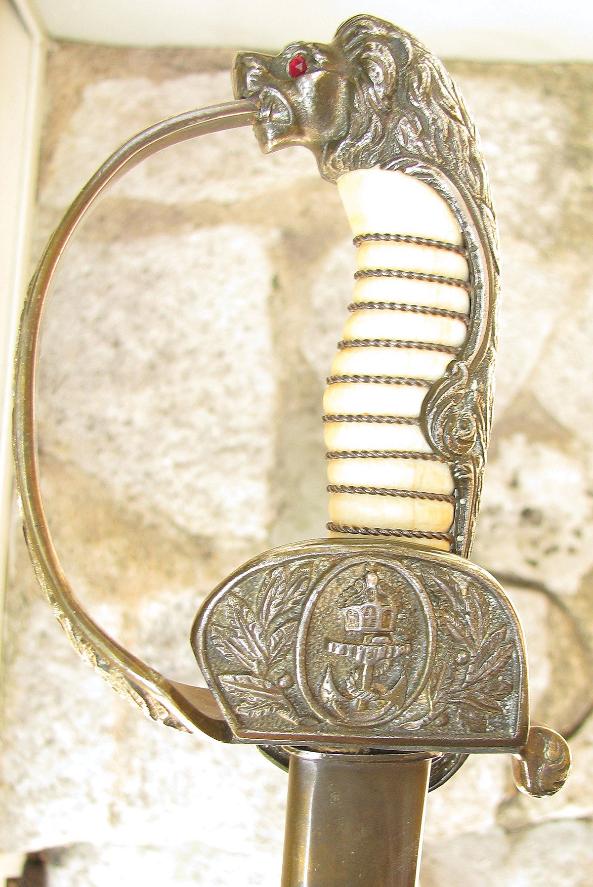The grip is genuine ivory with fire gild backstrap, pommel and cross guard. The lion’s head has green/red - fore/aft faceted glass