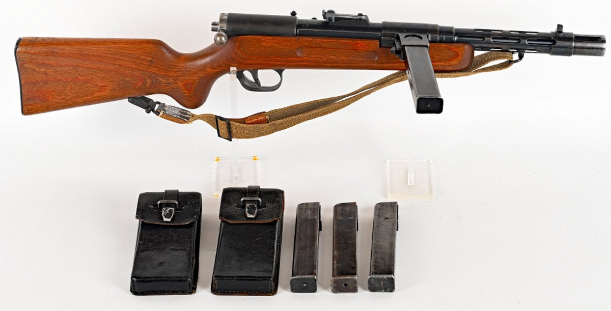 Rare and fully transferable BATF-NFA German Bergmann MP-35/I select-fire machine gun, manufactured 1933-1943 and SS marked. Fires semi-auto with single pull of the trigger or automatic with pull and hold. Design also features an easily removable barrel for cleaning and maintenance. This prized WWII model was supplied primarily to security forces and SS formations. Made from high-quality German milled-steel, this gun retains 75% original finish; has bright bore and very strong rifling. Comes with eight original 32-round magazines and canvas sling.