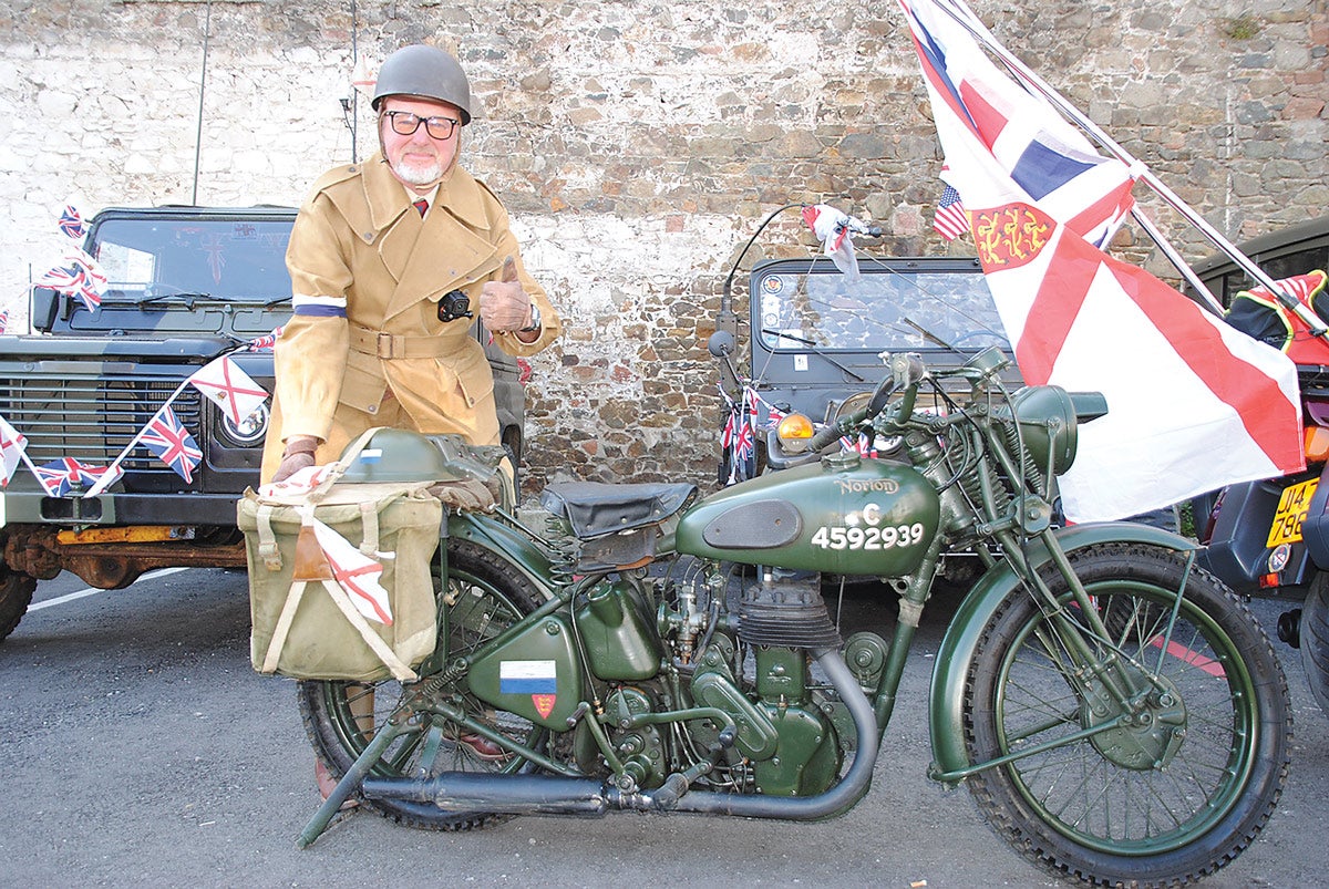 One of the escort motorcycle riders for the road run, Steve Bentley of the JMVG, with his 1945 Norton WD16H, which he has owned for 10 years. Bentley directed traffic at road junctions and led the way on the convoy.
