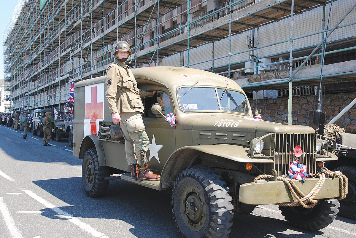 Seventeen-year-old Jared Key, portraying a 101st Airborne Division member hitching a ride on a Dodge WC54 ambulance.