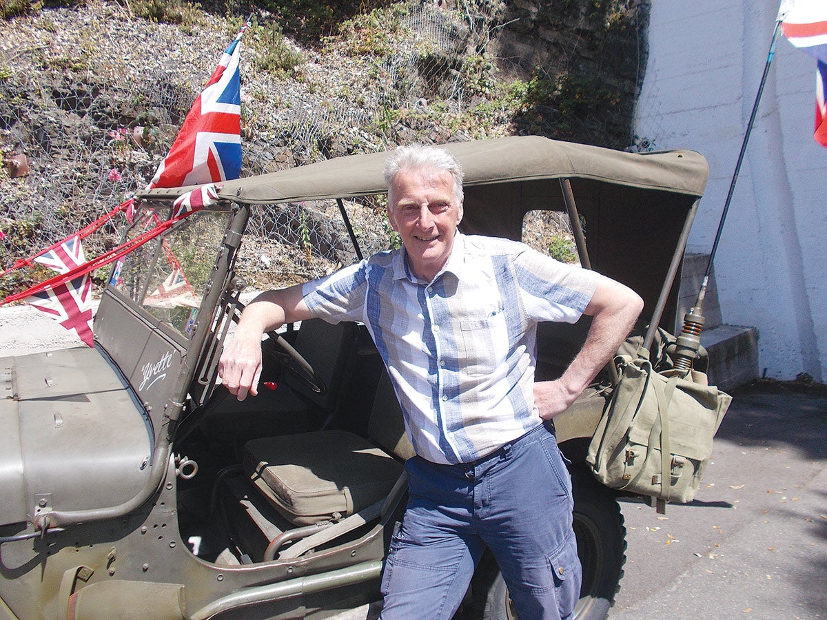 Your roving reporter takes a rest by the 1945 Willys Jeep he used to get around during the festivities and celebrations.