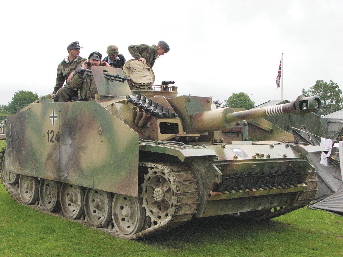 A replica Stug III meant to represent a late series Ausf F fitted with the long-barrelled 75mm gun. It is a good attempt at creating an operational Stug III for arena displays by re-enactors and is seen here with the unit badge for the 1st Parachute Division.