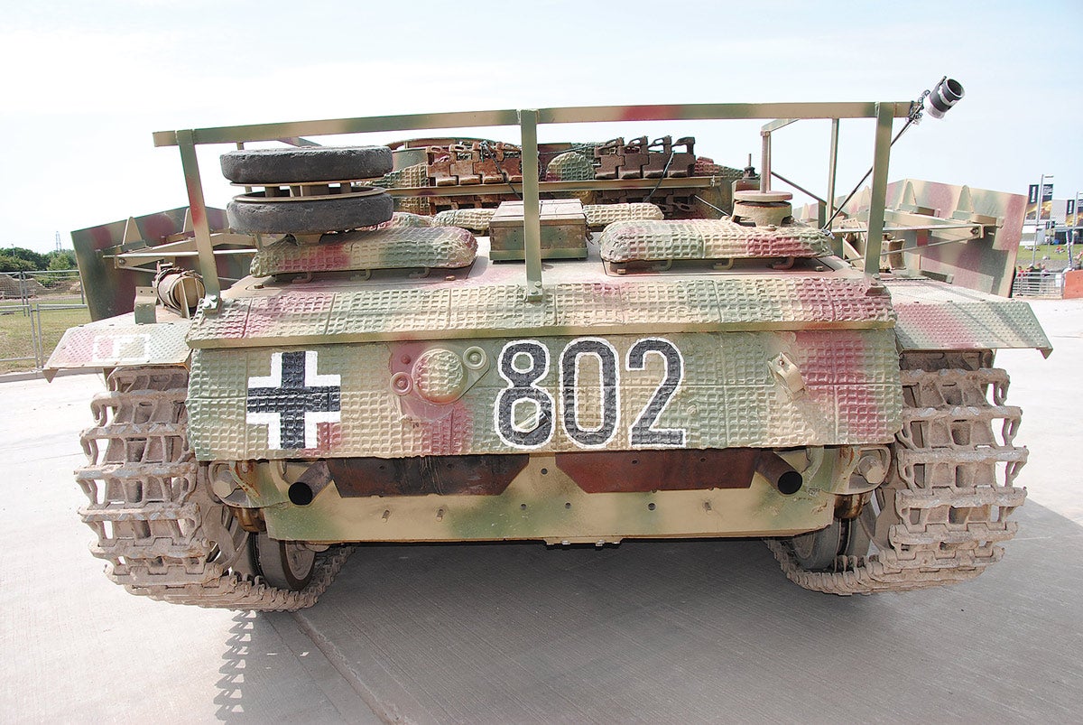 The twin exhausts extend from the rear-mounted Maybach engine, which is under the air-intake covers. The Zimmerit coating was developed in 1942 and applied to tanks and vehicles with casemate-mounted guns.