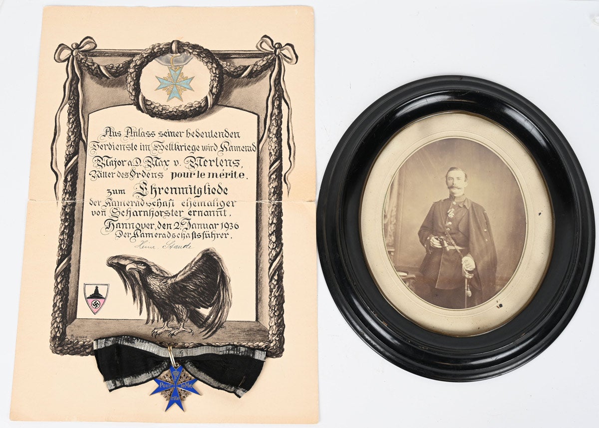 Extraordinary historical World War I Imperial German Pour Le Merite award winner’s archive belonging to Major Max von Mertens. Consists of ornate blue enamel and gilt Blue Max award from Aug. 8-9, 1918; NSKOV document awarded in 1936 in recognition of distinguished service during the World War; 28 calling cards from various officers, including several generals; three artillery shoulder straps, including one with rank of captain; flag remnants appearing to have come from funeral sashes; large photo lot; family ephemera including German Reich identity card.