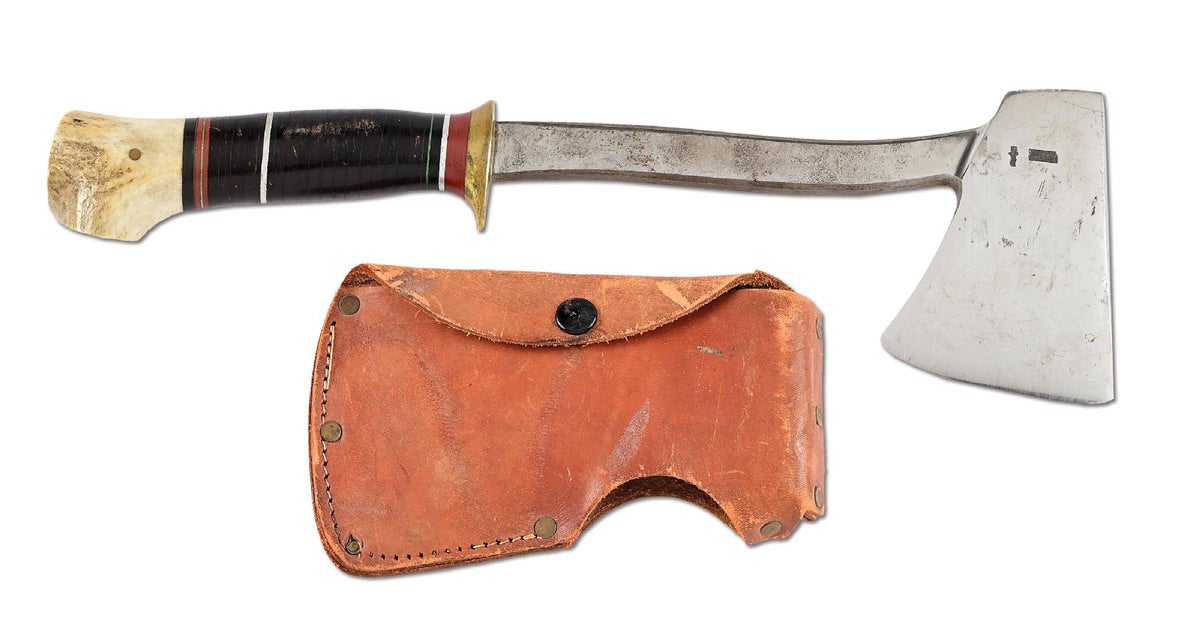Scarce handcrafted Bill Scagel hatchet or camp axe with leather scabbard, approximate overall length: 12 7/8in. Displays Scagel’s renowned Kris stamps and namestamp ‘W. SCAGEL / HANDMADE’ in small lettering on reverse cheek. Large pommel created from shaved antler. Obtained at Scagel’s property by a retired Muskegon, Michigan policeman who did carpentry jobs for the renowned bladesmith, including expansion of his home/workshop. Sold for $20,400 against an estimate of $10,000-$15,000