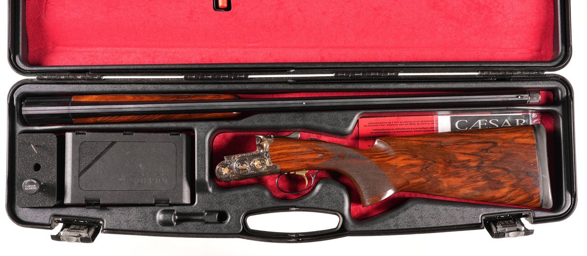 Caesar Guerini Invictus 12 gauge over/under shotgun manufactured in 2017. Specs: 30” modern barrel, 2¾” chambers, figured walnut stocks, diamond-point teardrop checkering, right-hand palm swell, midbead sight. Single select trigger, interchangeable chokes Skeet/Cylinder installed, LOP 14 7/8" with ejectors. Case-colored receiver. Engraved with gold inlay by Master Engraver Bottega Giovanelli. DOH 1 7/8", DOC 1¼”. A high-grade over/under shotgun for sporting clays.