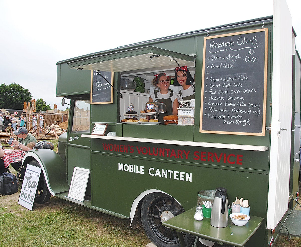 Chrissy, on the left, with Andrea serving tea with a smile from the back of “Martha”, which has been rescued and returned to her proper role of serving tea.