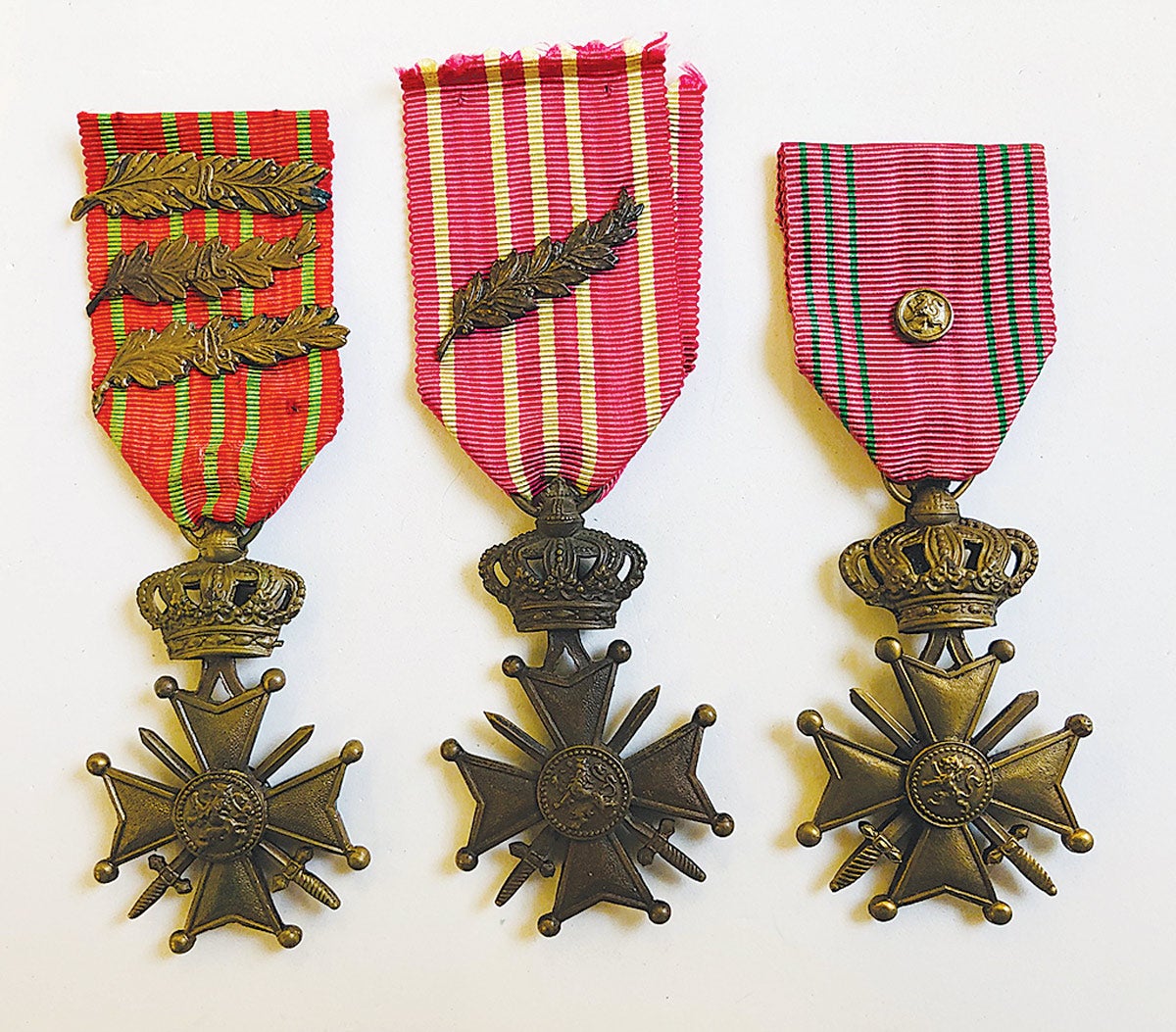 The WWI Belgium Croix De Guerre with three palms, a WWI Croix De Guerre with one Palm, and a WWII Croix De Guerre with bronze lion device.