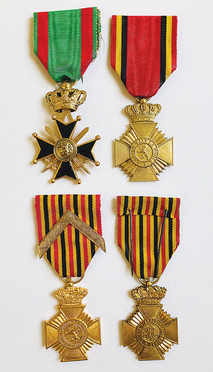 Top row: Belgium Military Cross, Military Decoration for Acts of Bravery. Bottom row: Military Decoration for Long Service - 1st Class (with Chevron), Military Decoration for Long Service - 2nd Class.