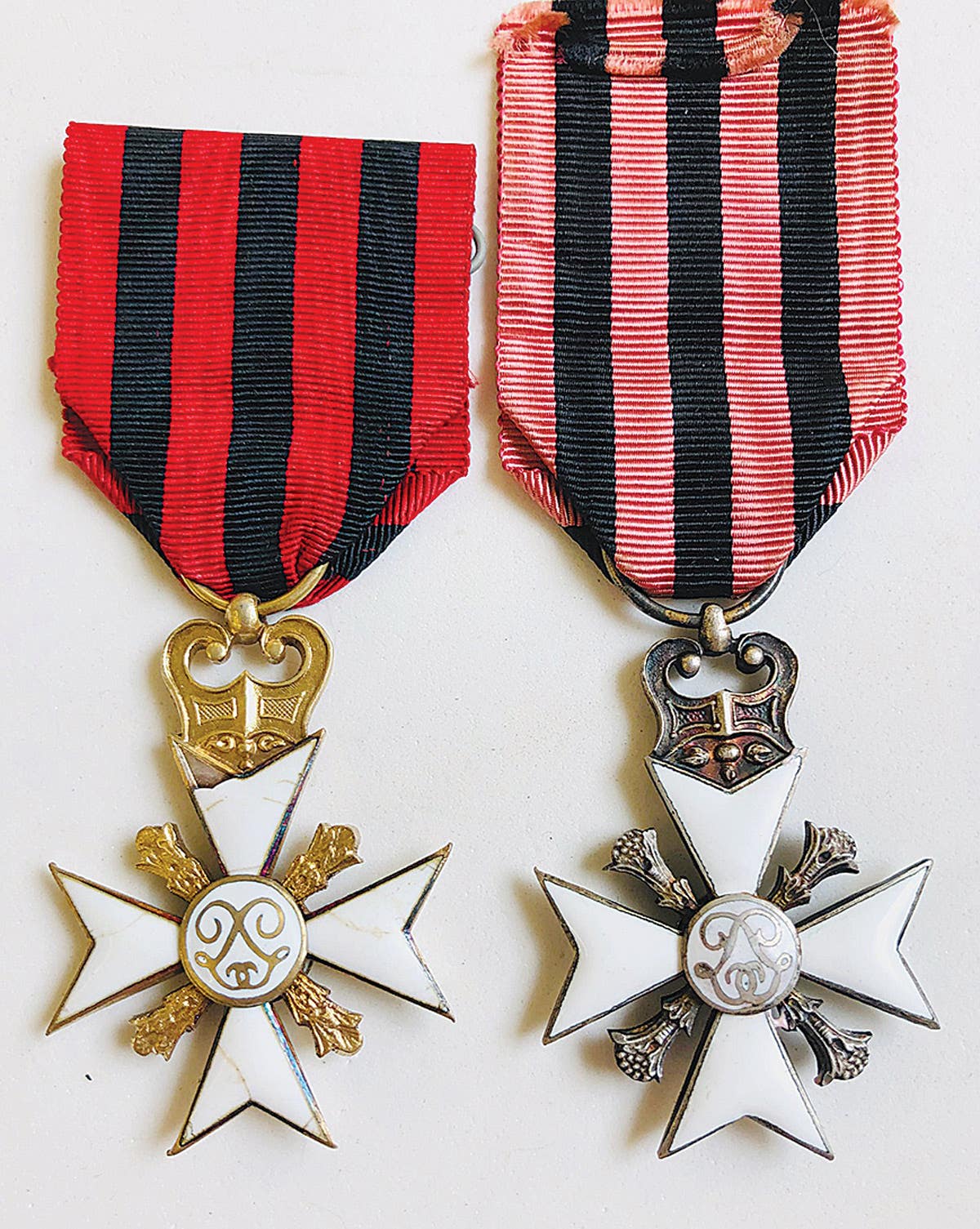 Civil Decoration Cross 1st class (gold) and Civil Decoration Cross 2nd class (Silver).