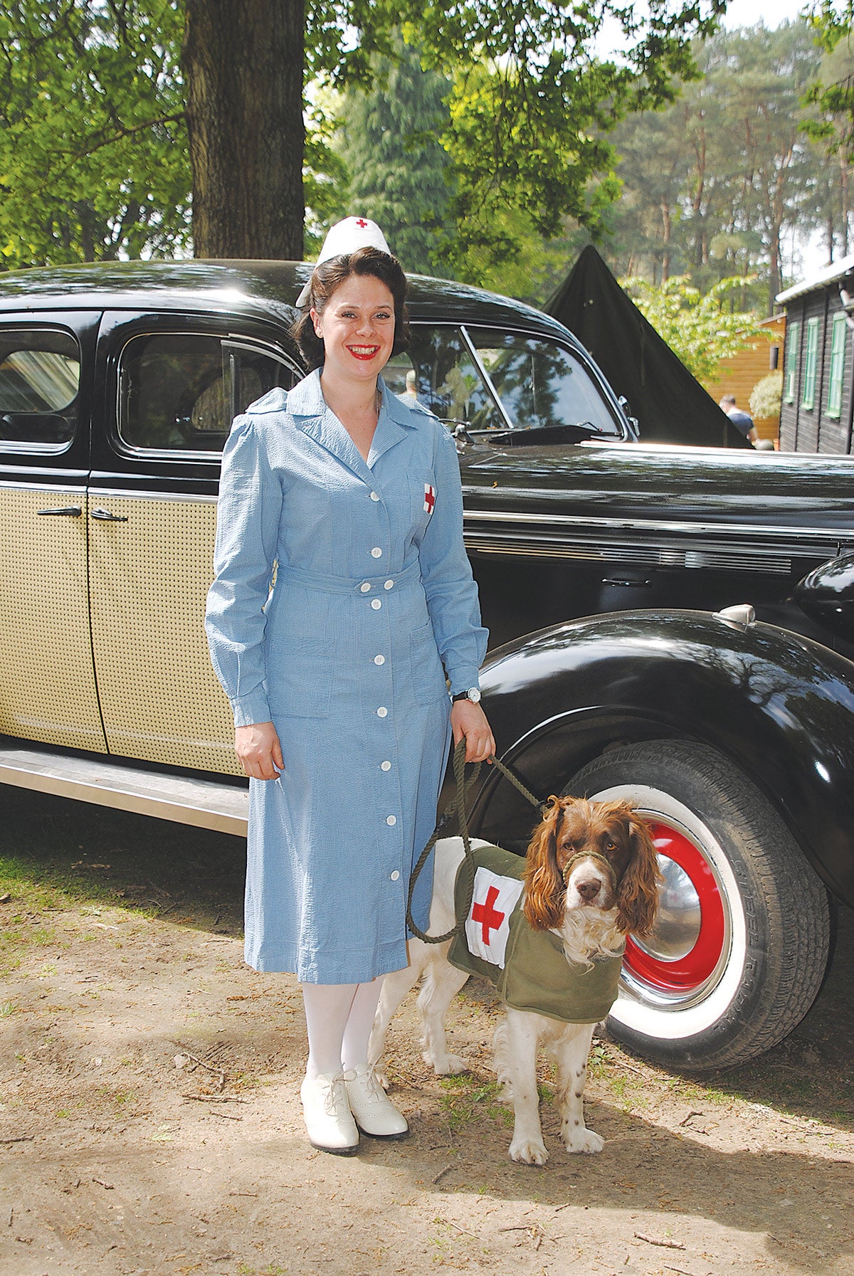 This charming re-enactor is ready to serve the American Red Cross nurse with her canine companion.