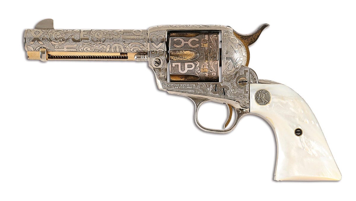 Colt Single Action Army .38 WCF Revolver manufactured circa 1919 with full-coverage cattle-brand engraving by Weldon Bledsoe. Cattle brands shown against punchdot background with scrollwork accents. Further embellished with nickel plating and gold wash on ejector rod housing, cylinder, and hammer. Mounted with 2-piece Colt mother-of-pearl grips featuring Rampant Colt medallion on each side.