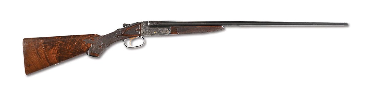 Ithaca Grade 7 NID 410, among the rarest of finely embellished American double guns. Serial No. 448950. One of only two .410s made by Ithaca in this grade, this very specimen was famously stolen in 1928 while on display at the Isaac Walton League in Omaha, Neb., and soon thereafter was sold. Later returned to rightful owners and remained with the family ever since. Entire production of the Grade 7 is listed in ‘The Ithaca Gun Company, From The Beginning’ by Walter Snyder. Exceptionally fine condition with beautiful factory embellishment and rose- and yellow-gold inlay. Receiver retains 98% of its gold-wash finish; barrels retain 98% of their factory-blued finish. Brilliant bores. Conveys with copy of Ithaca factory letter documenting October 1927 manufacture as a single-trigger Grade 7, with shipment to Ithaca’s marketing director John Boa. Absolutely fresh to the market.
