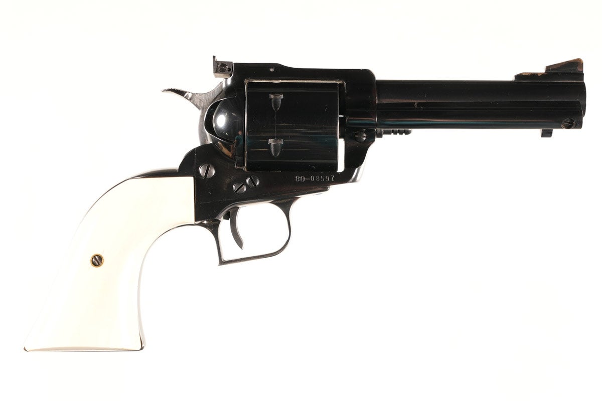 Customized Ruger Old Model Super Blackhawk .44 Magnum Revolver, Serial #80-08597, 4¾ in barrel. High-polish blue. Checkered wide hammer spur. Wide grooved trigger. Serrated rear sight. Finely tuned action has NOT been converted to Transfer Bar System. Genuine ivory grips have great color and grain and fit perfectly. Excellent condition with very few light handling marks. Provenance: Mike Stewart collection.