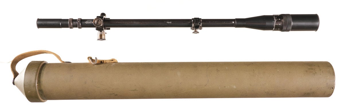 USMC J Unertl 8-power sniper scope with metal screw-in lens caps and scope rings with adjustment knobs, with original storage tube. Optic is slightly speckled, sight picture is clear with a crosshair reticle. This scope was issued to US Marine Corps snipers during World War II and the Korean War, mounted on the legendary M1903A1 Springfield and later Winchester Model 70 sniper rifles. Provenance: Tony Rodriguez collection. 