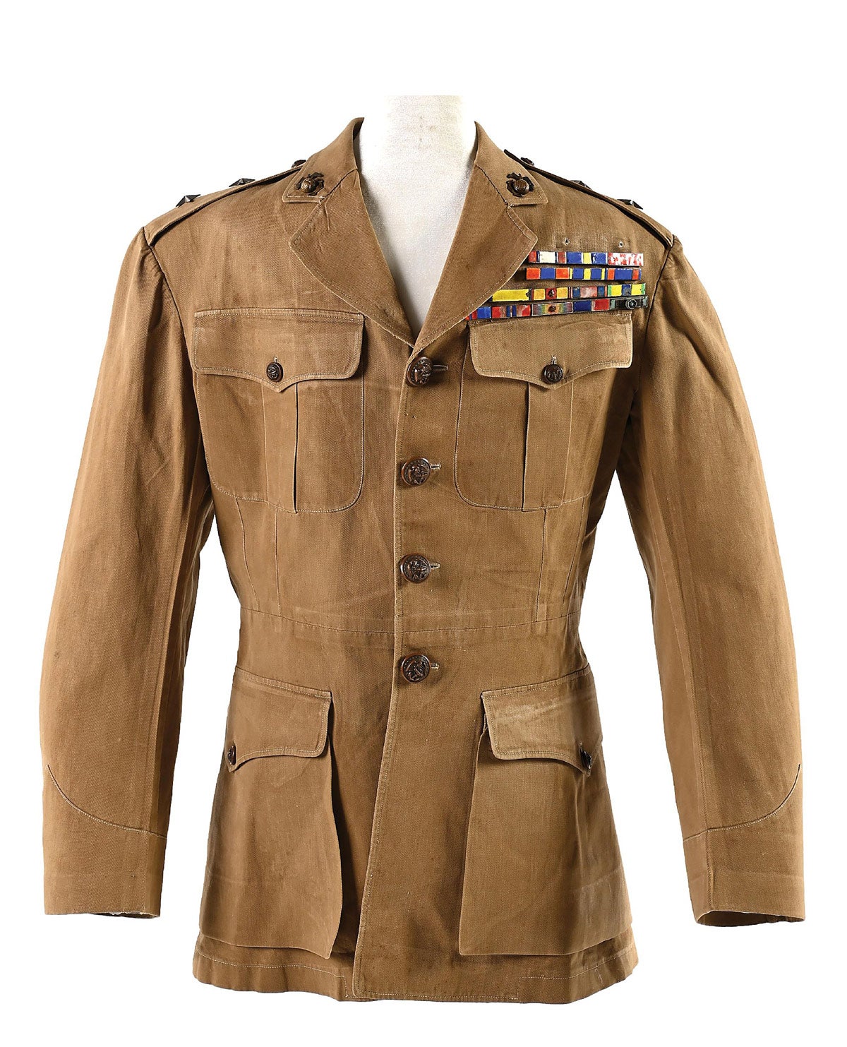 USMC uniform of Maj. Gen. Smedley Darlington Butler (1881-1940), one of only two Marines to be awarded two Medals of Honor, and the only officer to claim the title. Butler was one of the most decorated US Marines of all time, with an active-duty career that began in the Spanish-American War. He received 16 medals, including five for heroism, and the Marine Corps Brevet Medal. Unlined summer uniform made by a Chinese tailor, bears Chinese inked letters to the inside. Believed to have been made during Butler’s 3rd Brigade’s China Expedition. Cloisonne ribbon bars unquestionably made in China, likely Shanghai, and correspond to Butler’s awards. Lot includes undershirt and tie. Uniform remained with Butler’s family through the early 2000s, after which it passed into the collector community. VG condition.